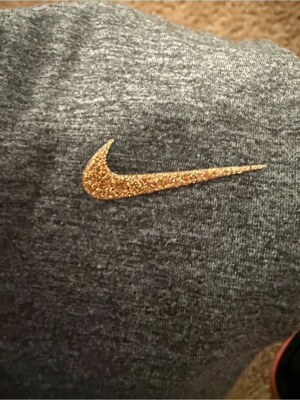 Nike women’s Charcoal Gray leggings with gold Swoosh